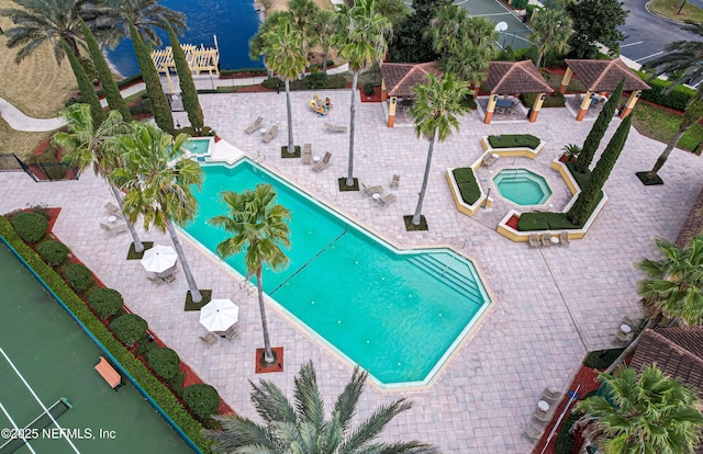 community pool with a patio area, a hot tub, and a gazebo