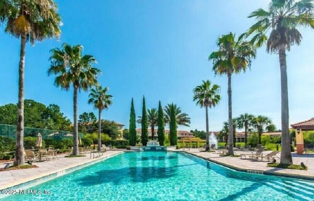 pool featuring a patio area and fence