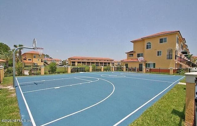 view of basketball court with community basketball court and fence