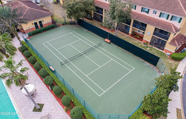 view of tennis court featuring fence