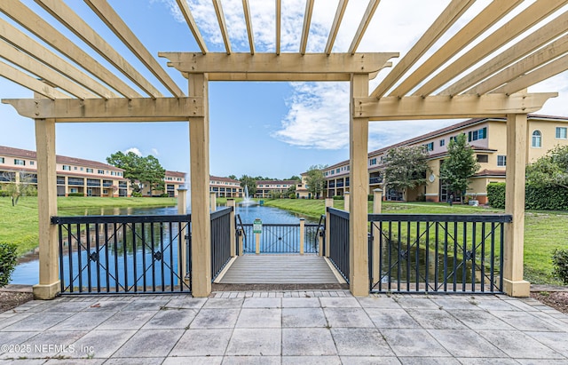 view of patio / terrace with a water view and a pergola