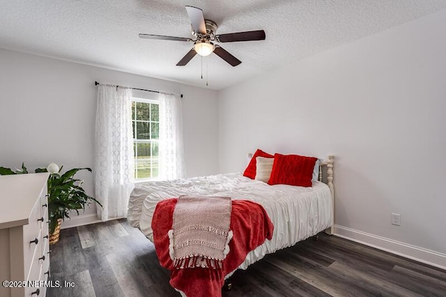 bedroom featuring a textured ceiling, dark wood-style flooring, a ceiling fan, and baseboards