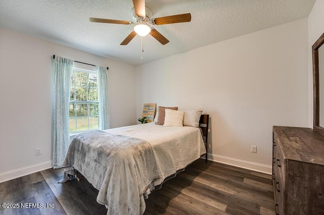 bedroom featuring dark wood-style floors, ceiling fan, baseboards, and a textured ceiling