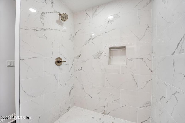 bathroom featuring a tile shower