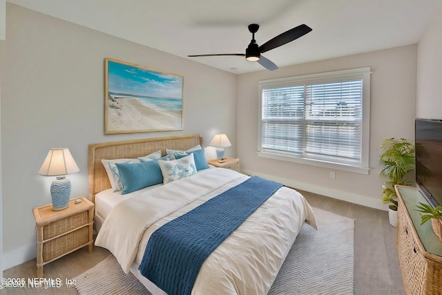 bedroom featuring a ceiling fan and baseboards