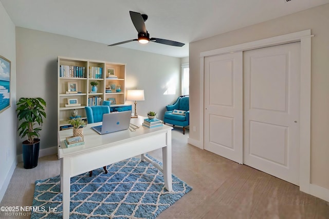 office area featuring baseboards and a ceiling fan