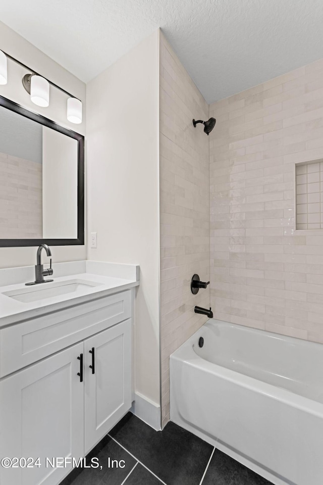 full bath with a textured ceiling, vanity, bathing tub / shower combination, and tile patterned floors