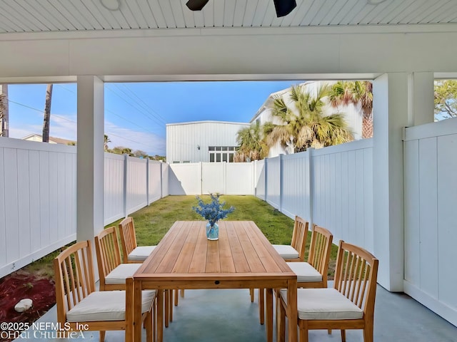 view of patio featuring a fenced backyard, outdoor dining area, and a ceiling fan