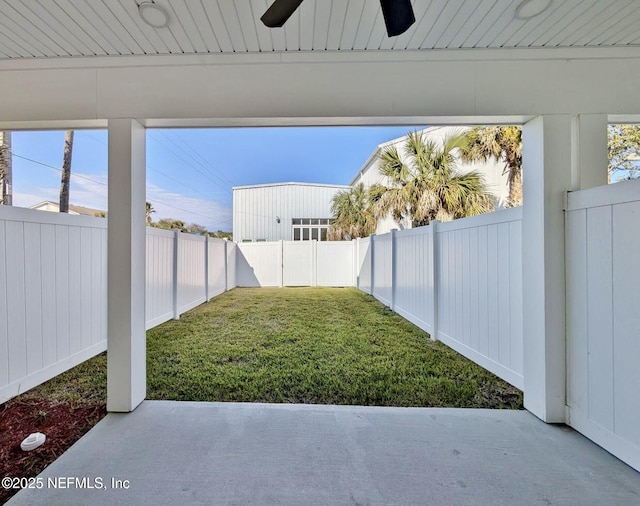 view of yard with a ceiling fan, a patio area, and a fenced backyard