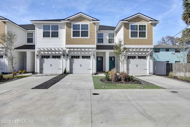 view of front of house featuring concrete driveway and fence