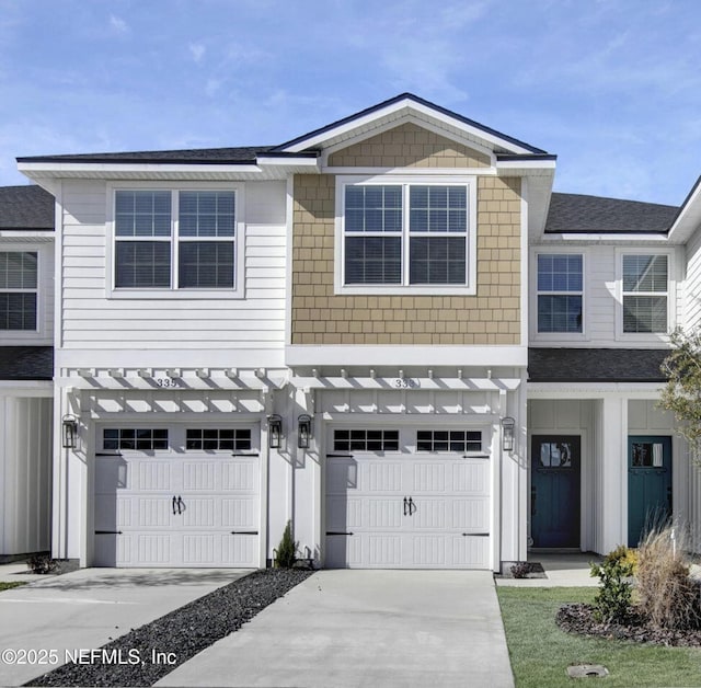 view of property featuring driveway and an attached garage