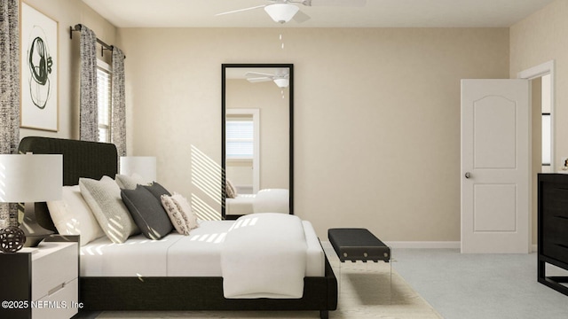 carpeted bedroom with ceiling fan and baseboards