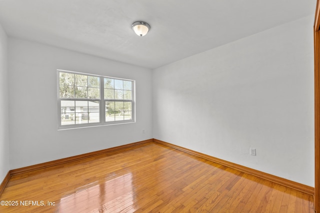 empty room with light wood-style floors and baseboards