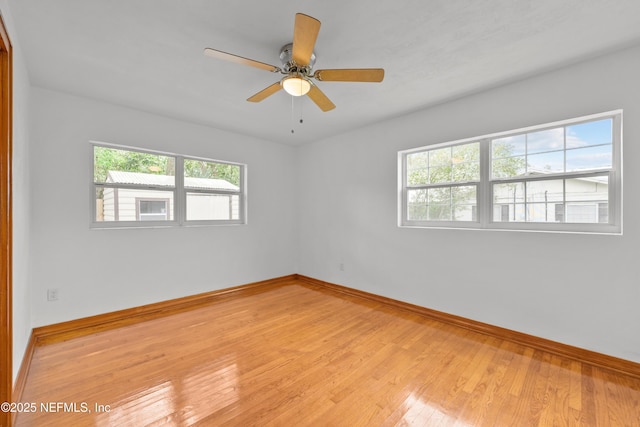 empty room with light wood-type flooring, ceiling fan, and baseboards