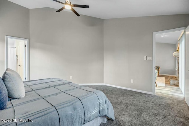 carpeted bedroom with a ceiling fan, lofted ceiling, and baseboards