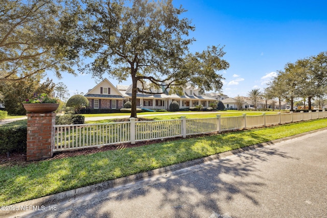 view of front of property featuring a fenced front yard and a front lawn