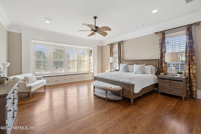 bedroom featuring ornamental molding, wood finished floors, and recessed lighting