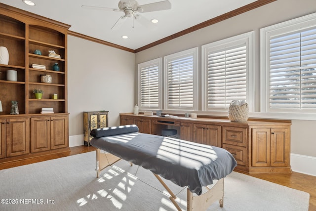 bedroom featuring light wood-type flooring, multiple windows, and ornamental molding