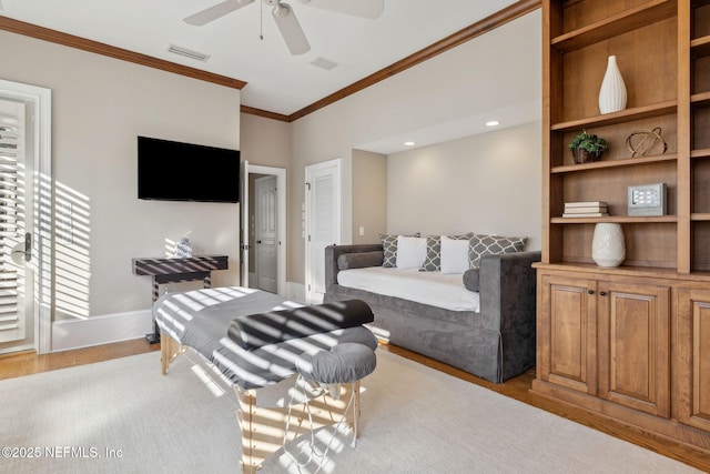 living area featuring visible vents, ornamental molding, ceiling fan, wood finished floors, and baseboards