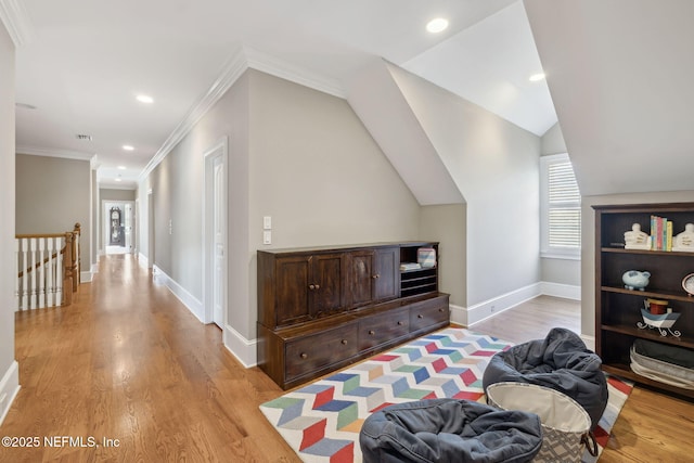 interior space with baseboards, an upstairs landing, and light wood-style floors