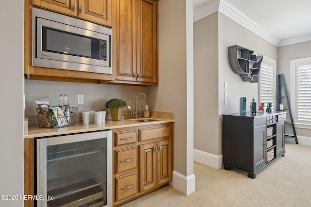 bar with light carpet, wine cooler, stainless steel microwave, ornamental molding, and a sink