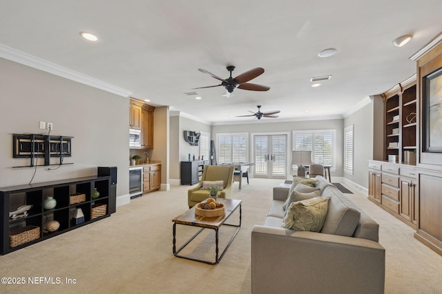 living area featuring light carpet, baseboards, wine cooler, and ornamental molding