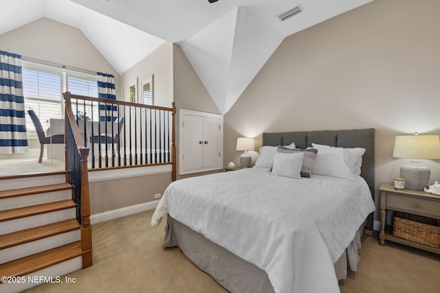 carpeted bedroom featuring vaulted ceiling, visible vents, and baseboards