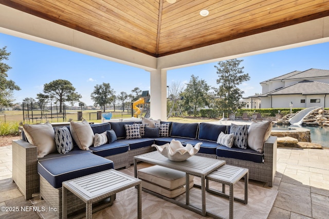 view of patio with fence and outdoor lounge area