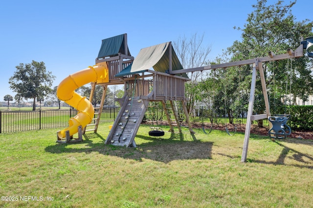 view of playground featuring fence and a lawn