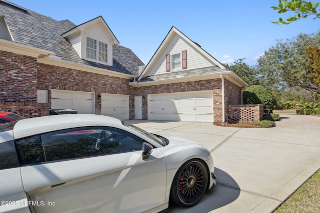 view of home's exterior featuring a garage, driveway, and brick siding