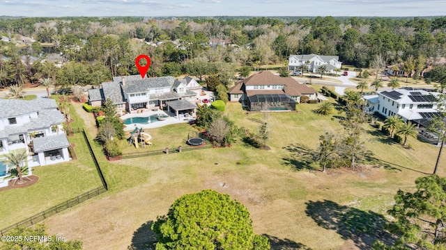 drone / aerial view with a wooded view and a residential view