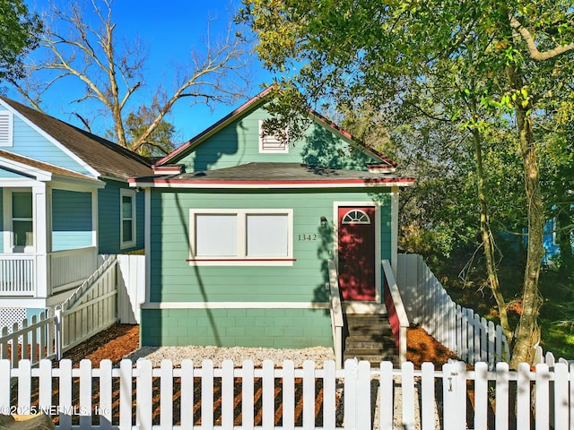 bungalow-style home featuring a fenced front yard