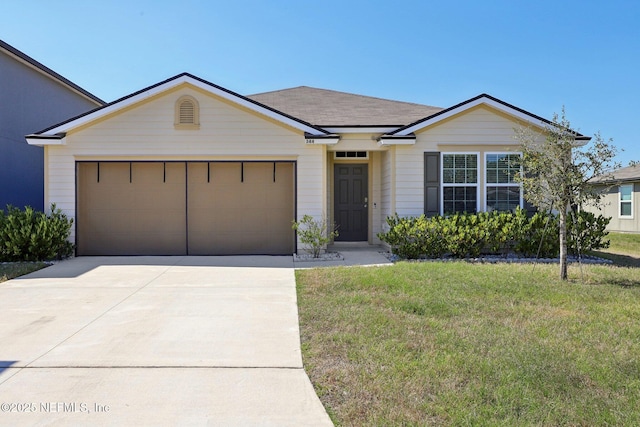 ranch-style home with a front yard, concrete driveway, and an attached garage