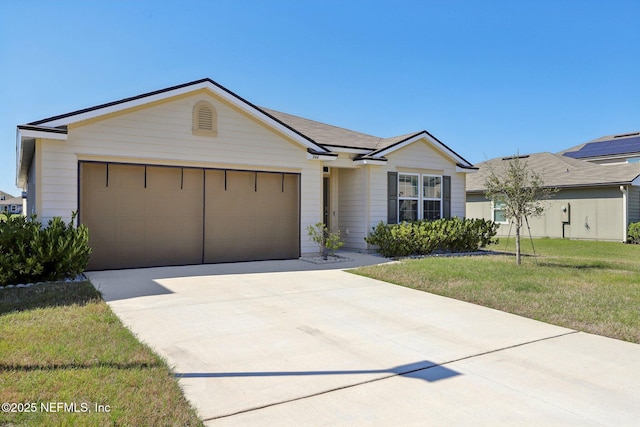 ranch-style house featuring a garage, concrete driveway, and a front yard