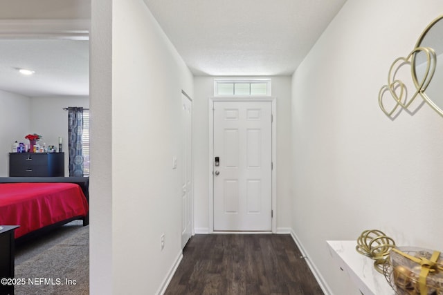 doorway to outside with a healthy amount of sunlight, baseboards, and wood finished floors