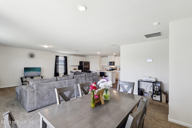 dining space featuring carpet floors, baseboards, visible vents, and recessed lighting