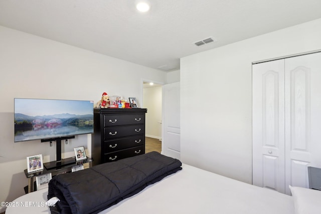 bedroom with a closet and visible vents