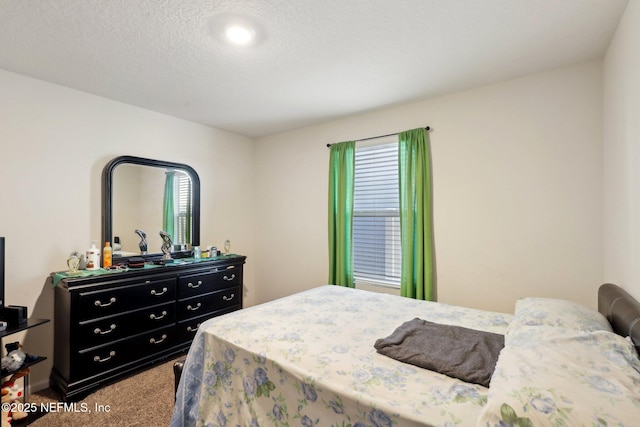 carpeted bedroom with a textured ceiling