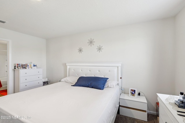 bedroom featuring dark colored carpet and visible vents