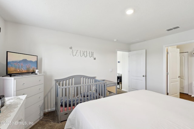 bedroom featuring visible vents and dark carpet