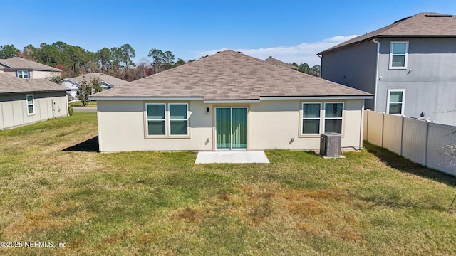 back of property featuring a lawn, cooling unit, fence, and stucco siding