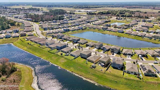 birds eye view of property featuring a water view and a residential view