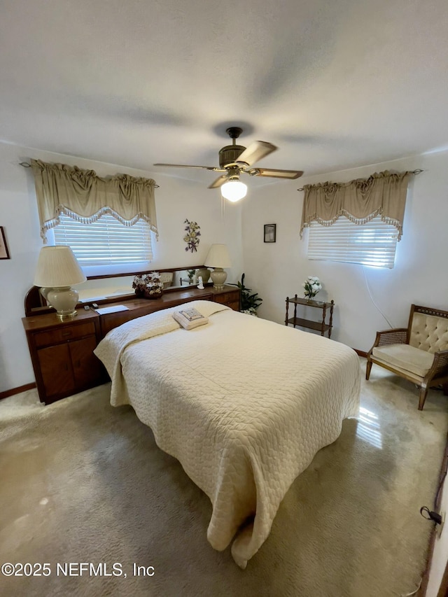 bedroom featuring a ceiling fan and light colored carpet