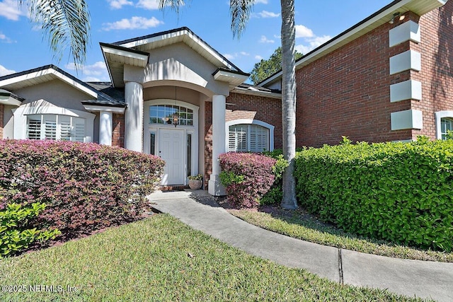 exterior space with brick siding and stucco siding