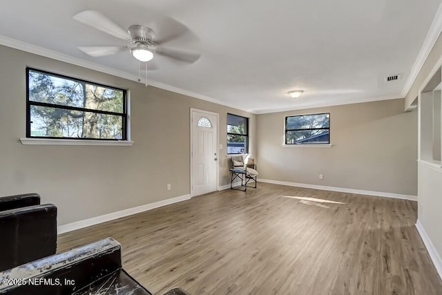 interior space with ornamental molding and wood finished floors