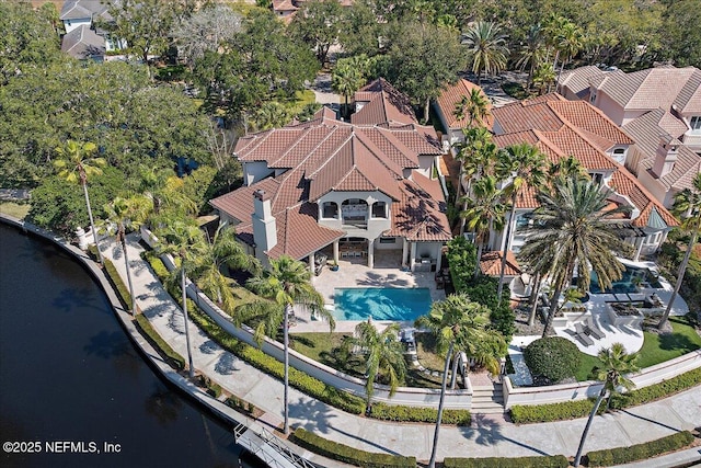 birds eye view of property with a water view and a residential view