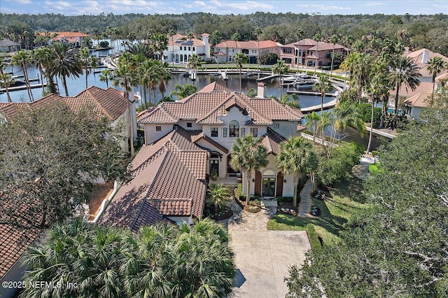 drone / aerial view featuring a residential view and a water view