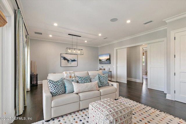 living room with hardwood / wood-style flooring and crown molding