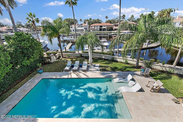 outdoor pool with a patio, a water view, and fence private yard