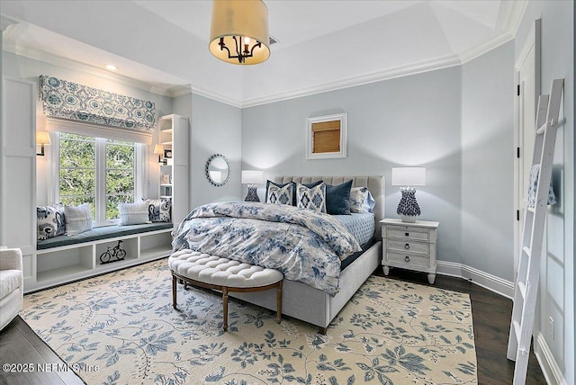 bedroom with crown molding, baseboards, and wood finished floors